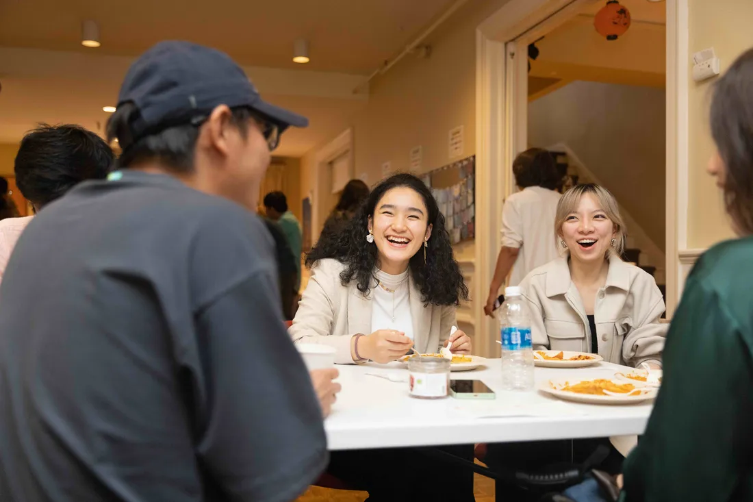 Students sitting together and laughing.