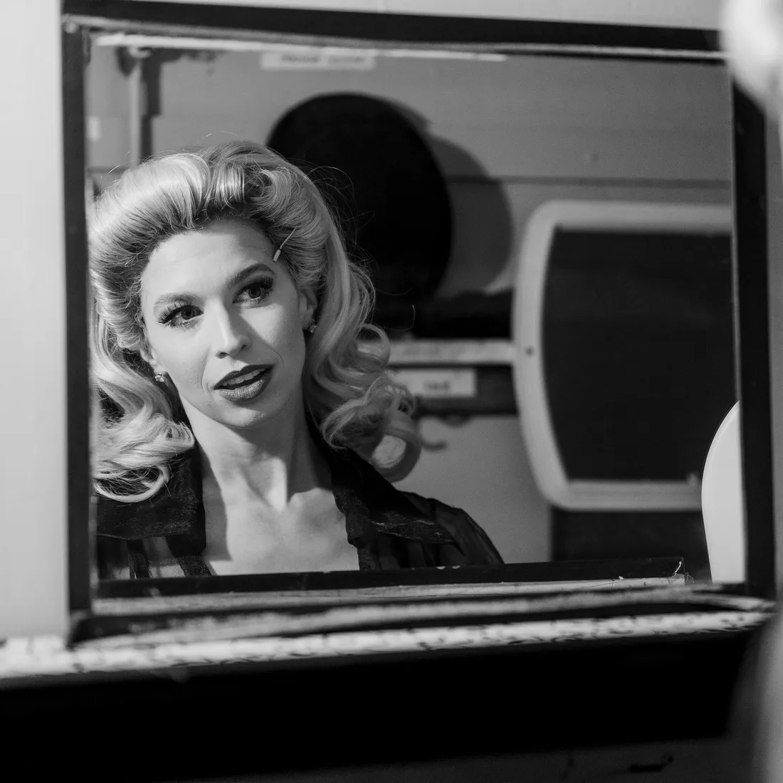 Broadway star looking at herself in the mirror.