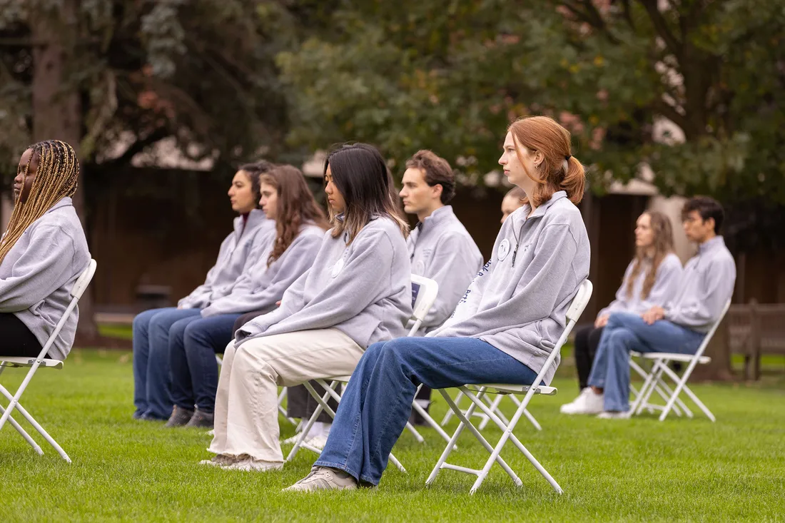 People sitting in chairs on the lawn.