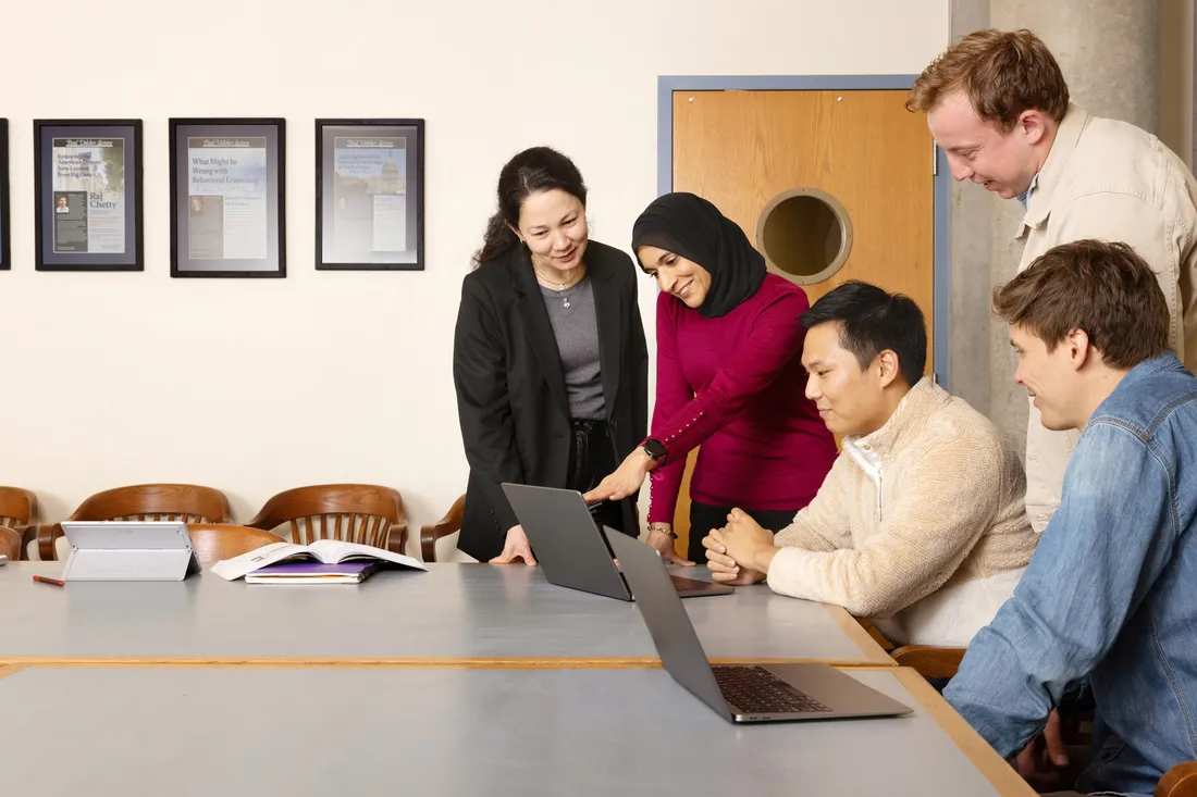 Group of students looking at computer together.