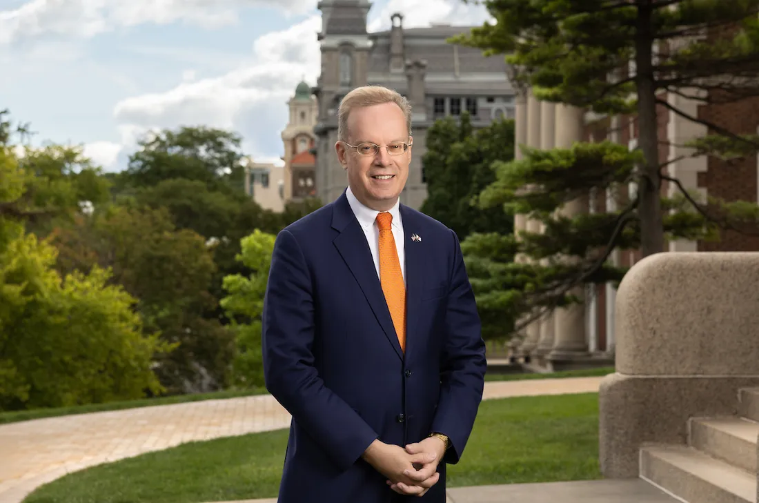 Chancellor Kent Syverud standing and smiling.