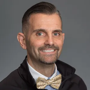 Jonah Fugo smiling with a gold bow tie on.