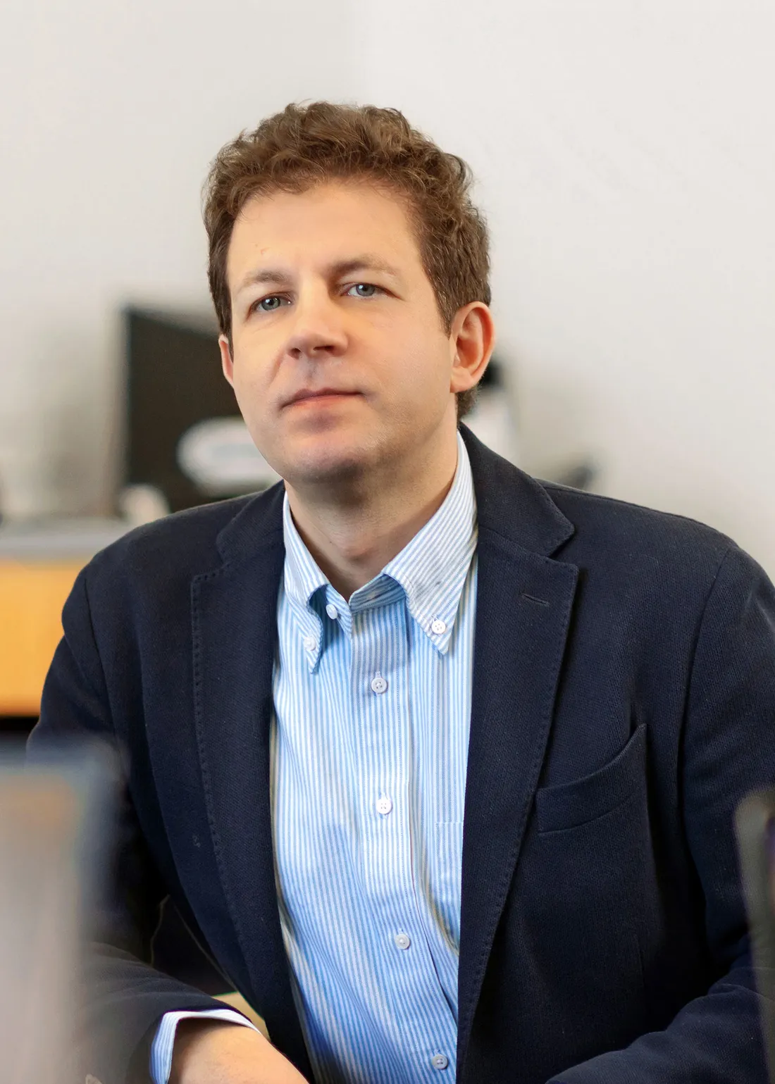 Johannes Himmelreich inside a classroom sitting.