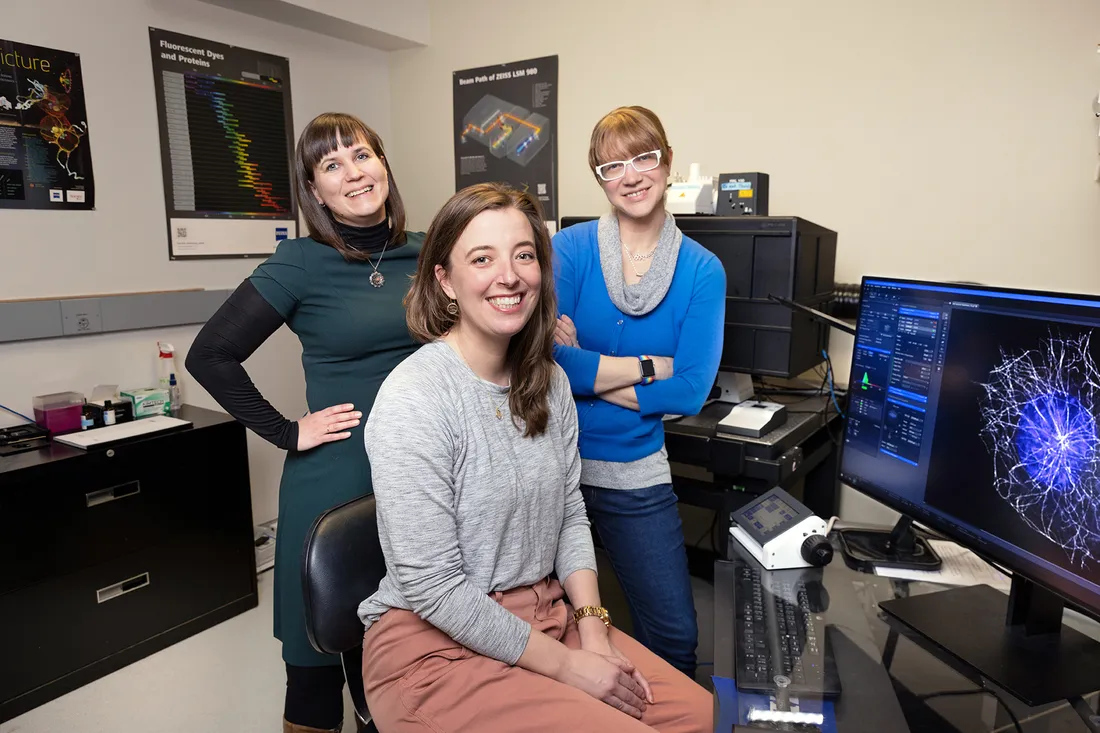 Three female research professors smile for picture.