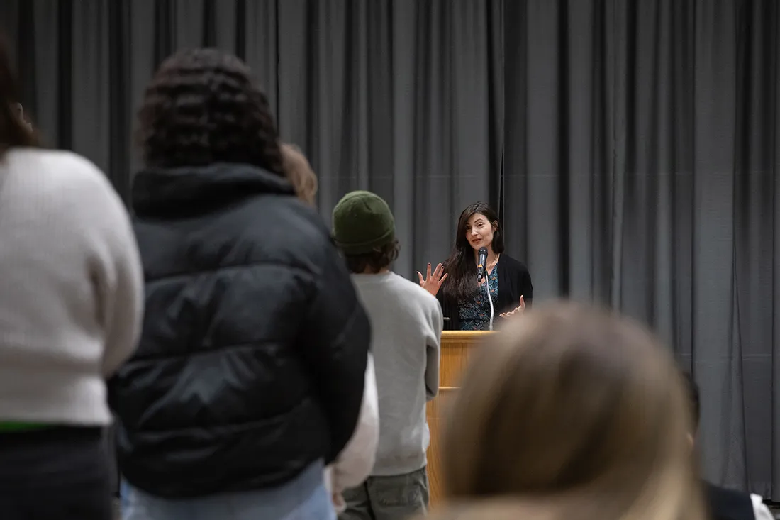 Mona Awad speaking at a lecturn.