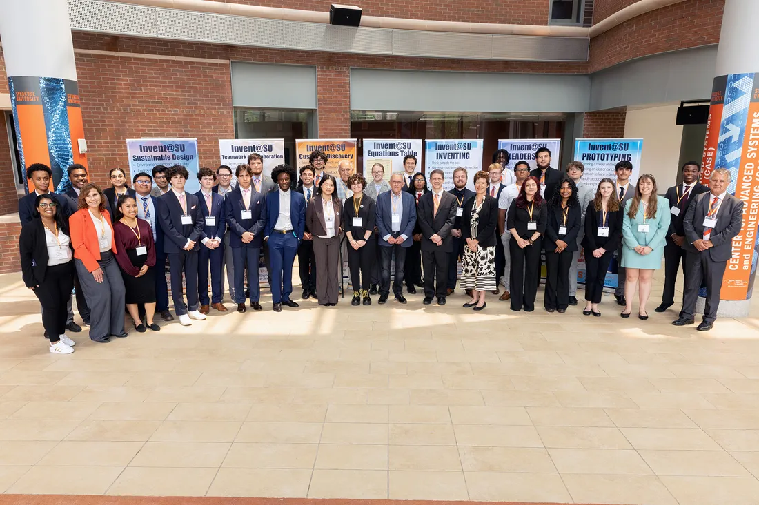 Group of students pose for photo in business clothes.