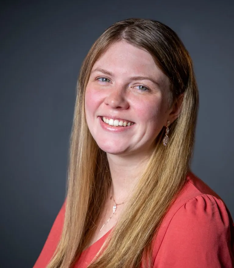 Kali Hoppe smiling with her head turned to the side.