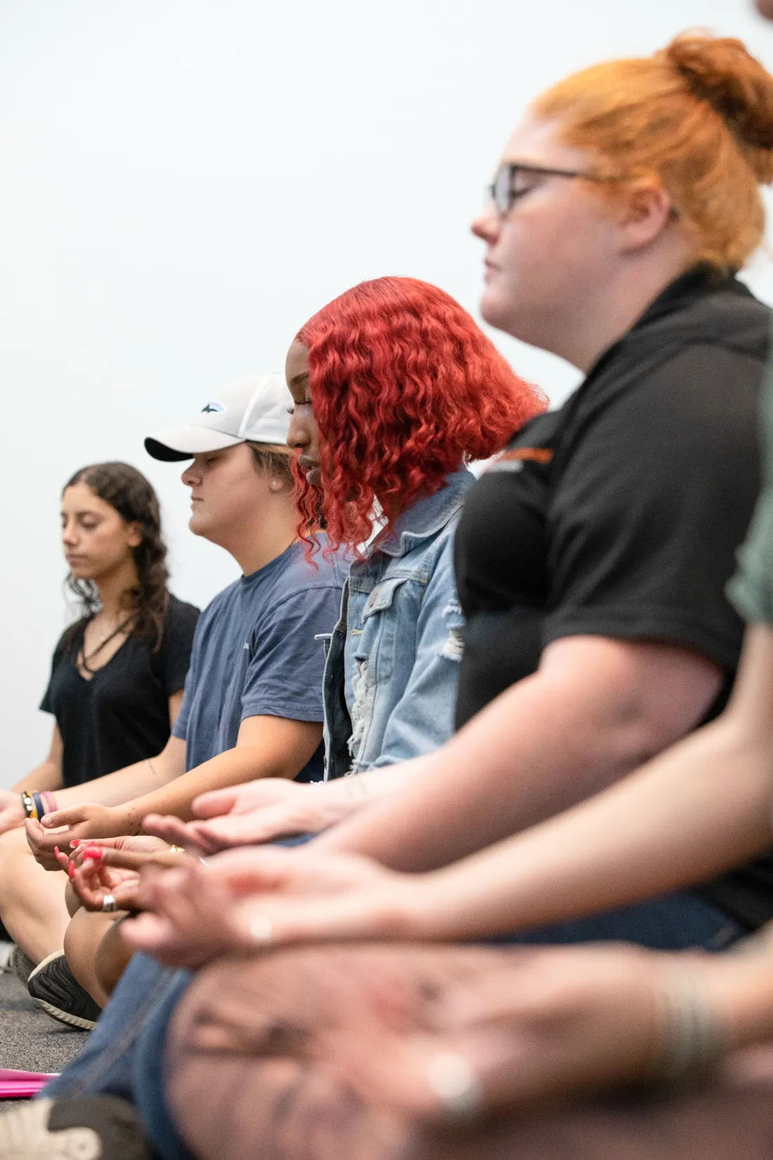 Four people sitting in meditation.