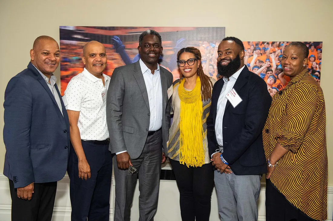 Portrait of Mariama Boney smiling with five other alumni.