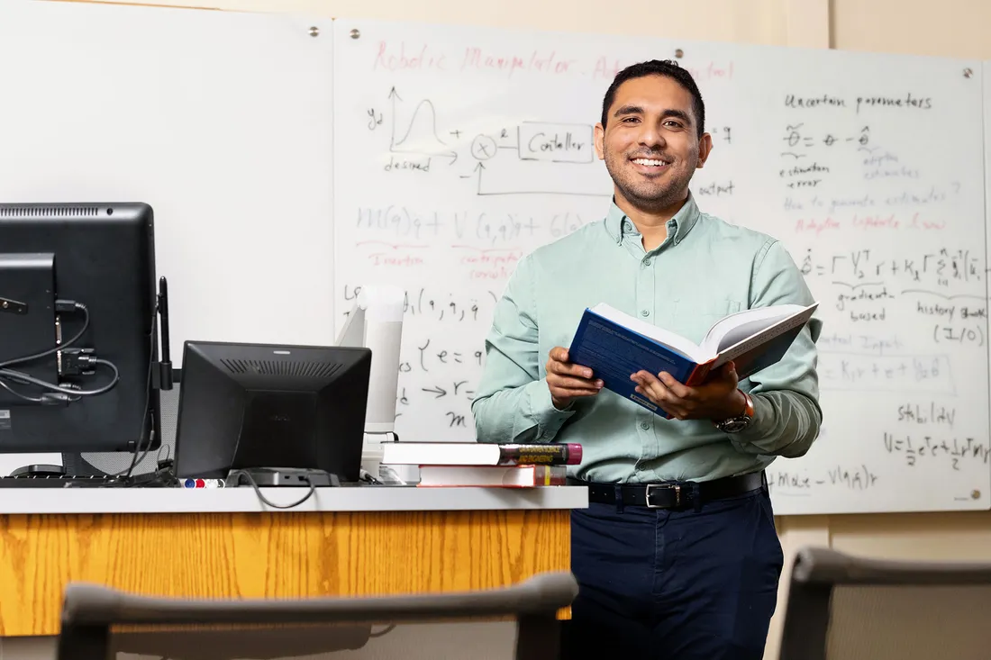 Portrait of professor Victor Duenas in lab.