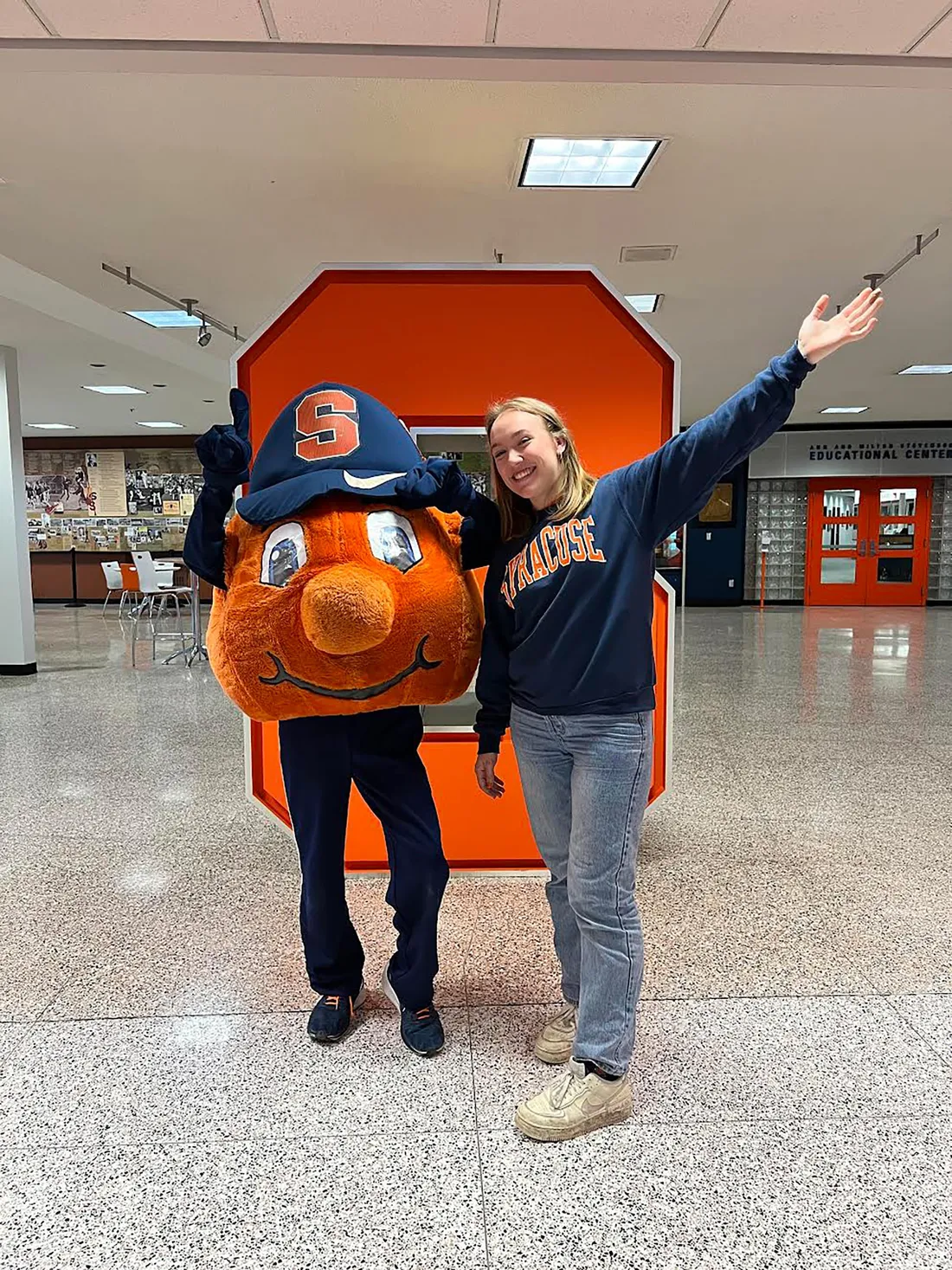 Moriah Humiston standing next to Otto in front of a block S.