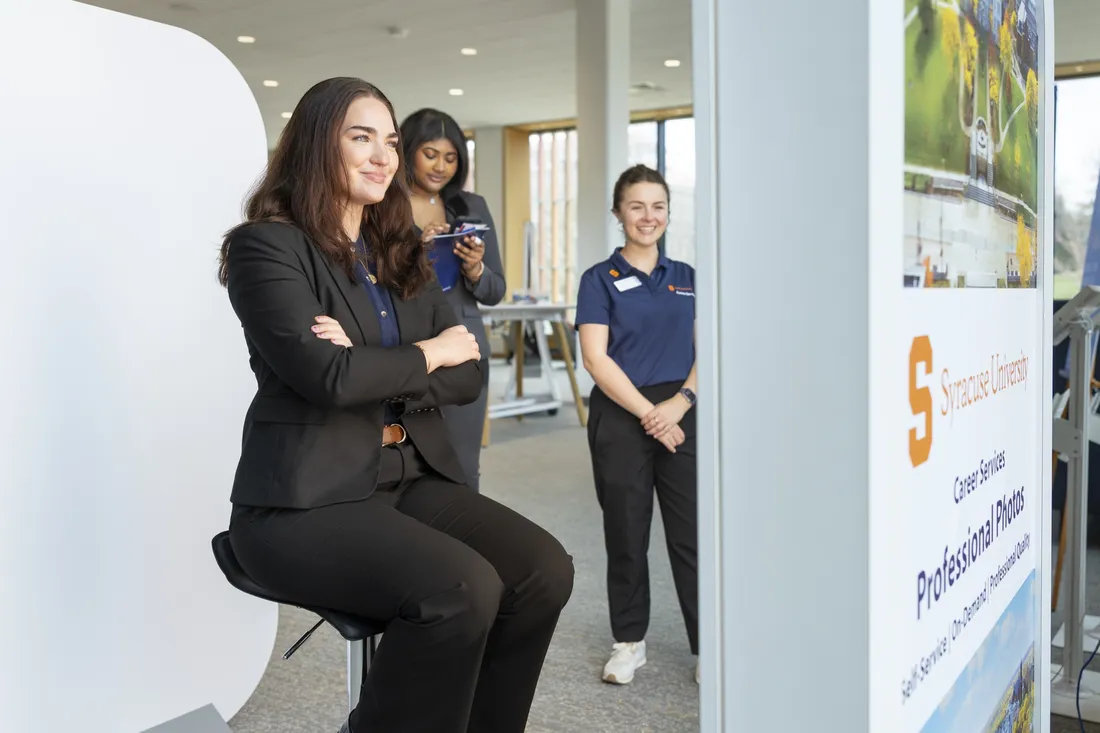 Student posing for a headshot photo at the Career Services' photo booth provided at the Syracuse University Career Conference.