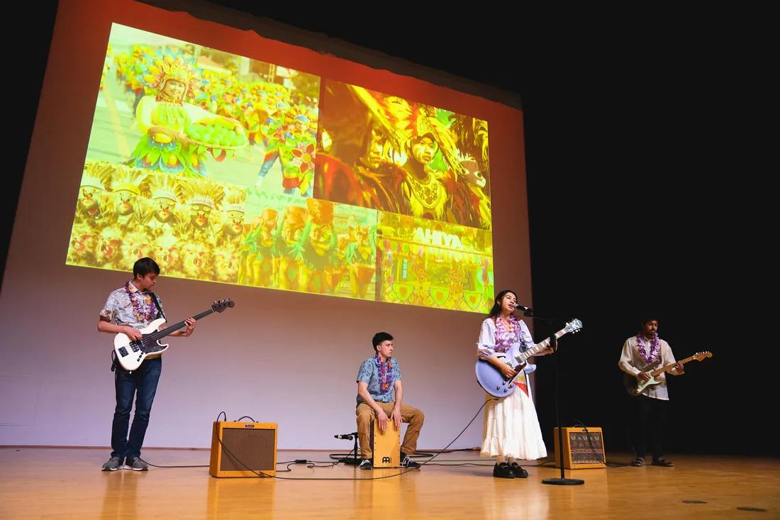 Students play instruments on stage at International Festival.