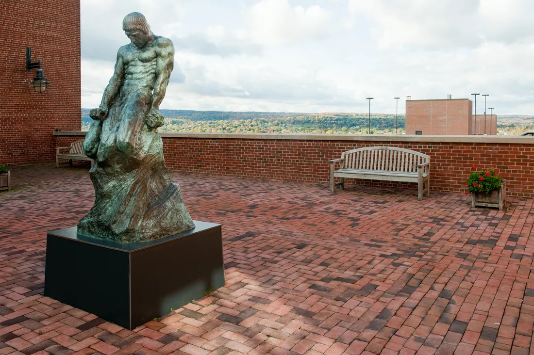 Sculpture of elemental man located outside of Falk College.