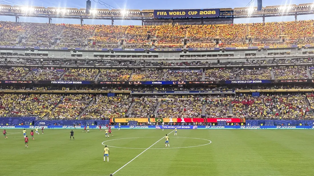 Soccer players playing a game at MetLife Stadium for the World Cup.