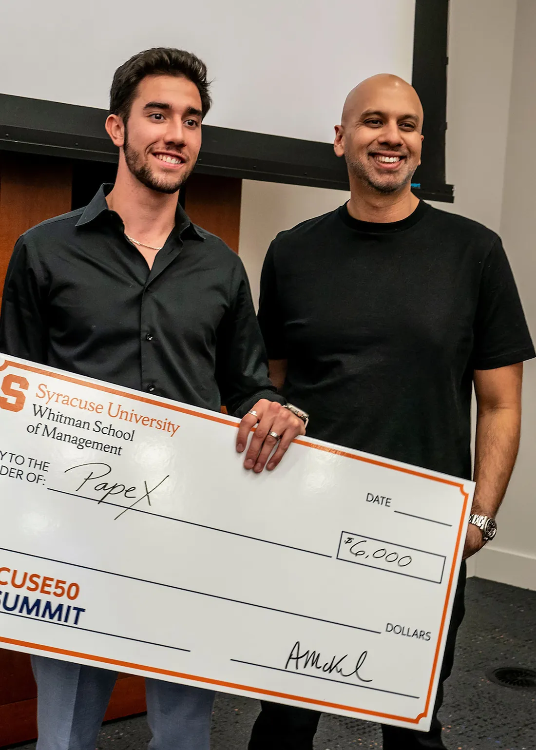 People holding a big check.