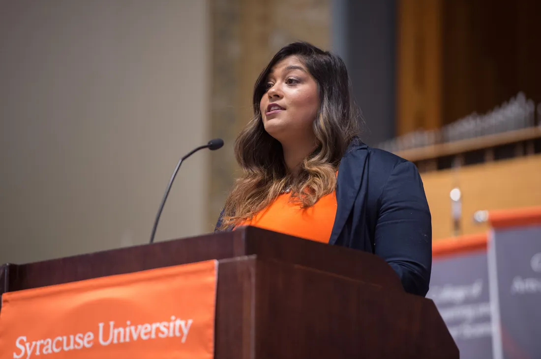 A person speaking at a podium.