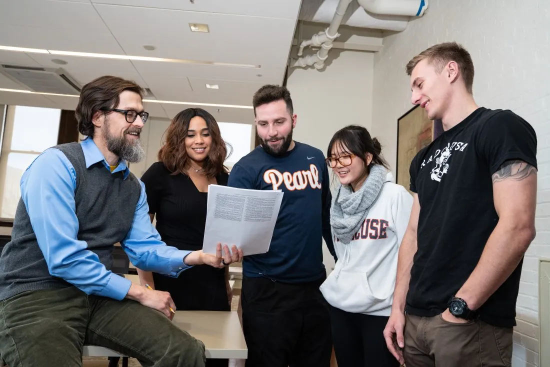 Professor speaking with students.