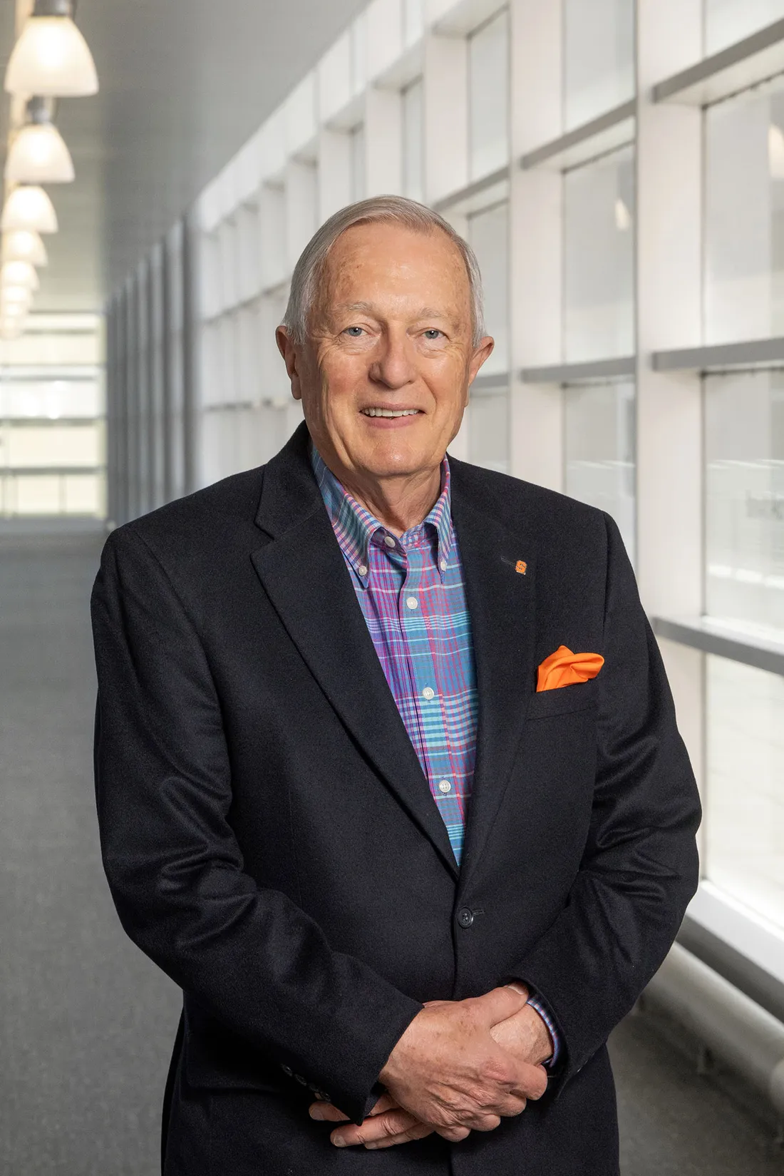 A headshot of Jack Kreischer standing in a hallway in a suite.