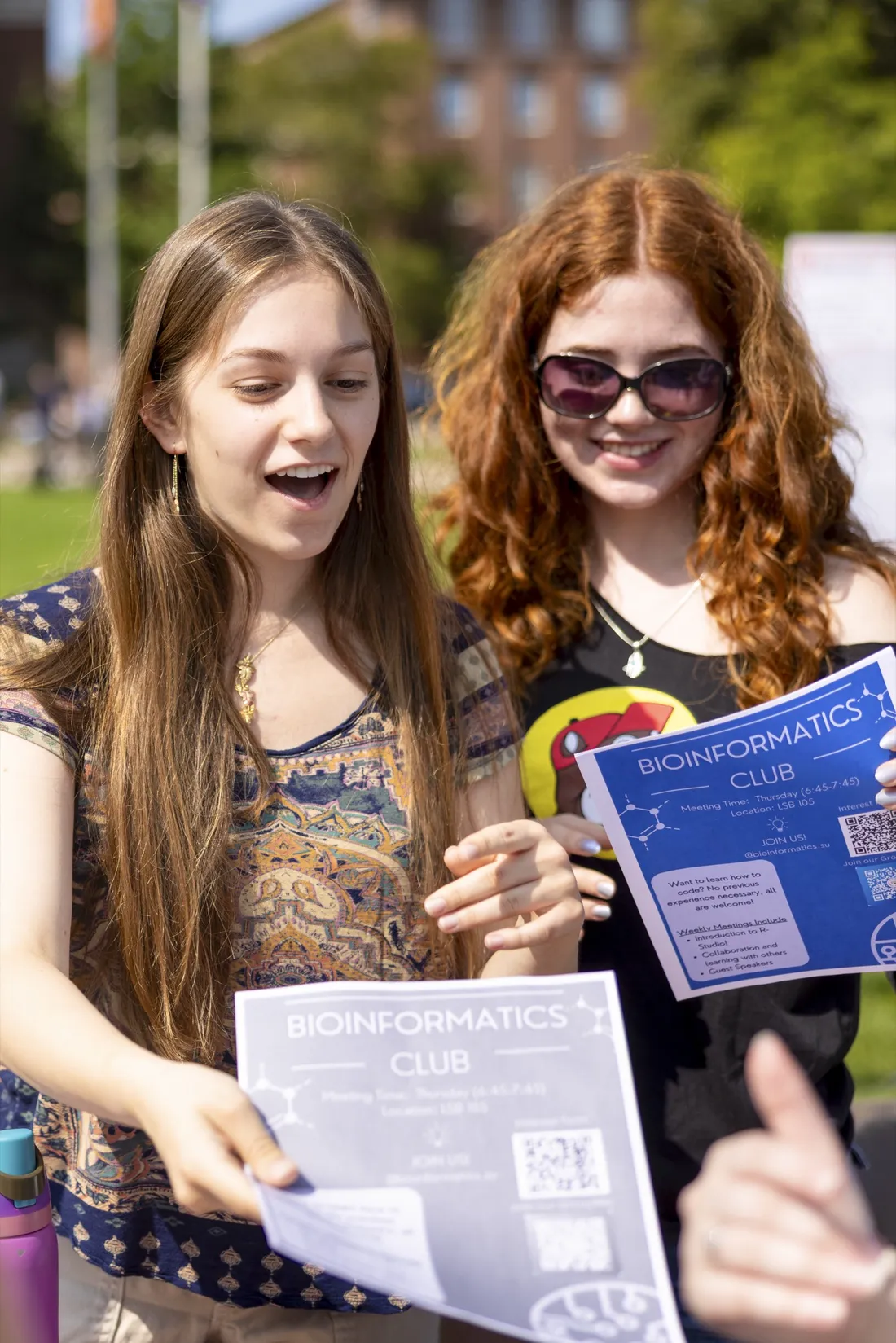 Two students looking at brochures.