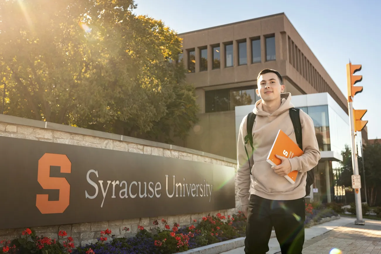 Student walking outside on Syracuse University's campus.