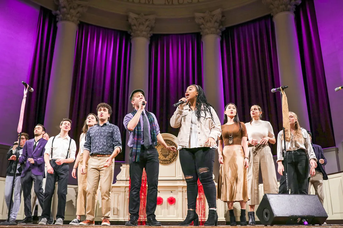 members of Groovestand an a cappella group, sing on stage