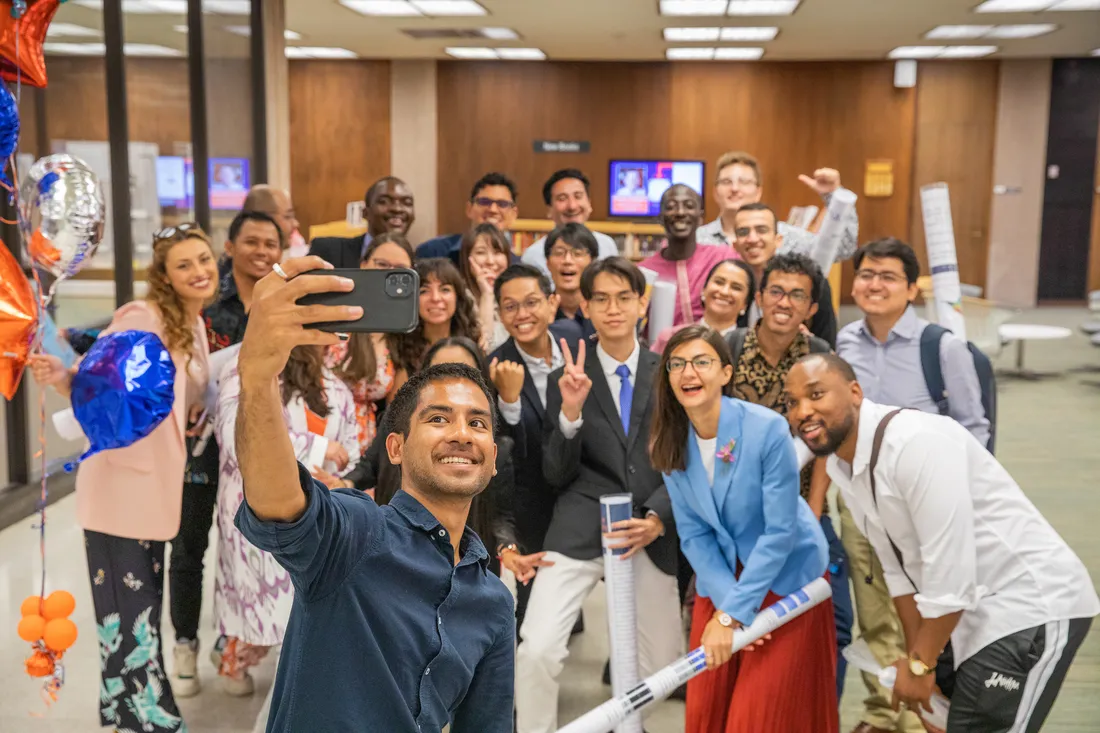 A group of people taking a selfie.