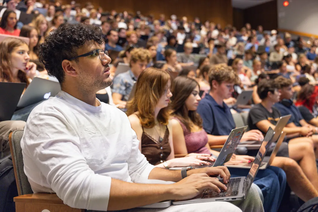 Student sitting in a lecture hall.