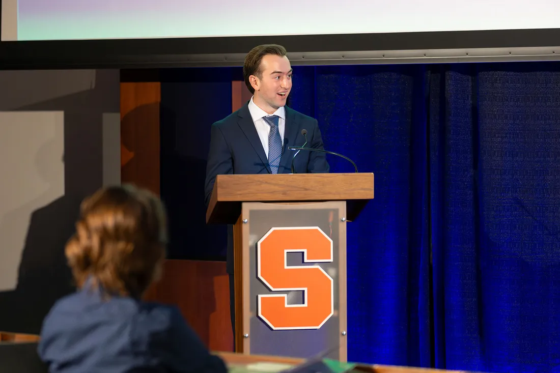 Person giving a presentation while standing at a podium.
