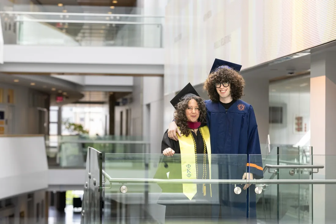 Dara Harper G'26 and Rio Harper '26 standing together and smiling in their caps and gowns.
