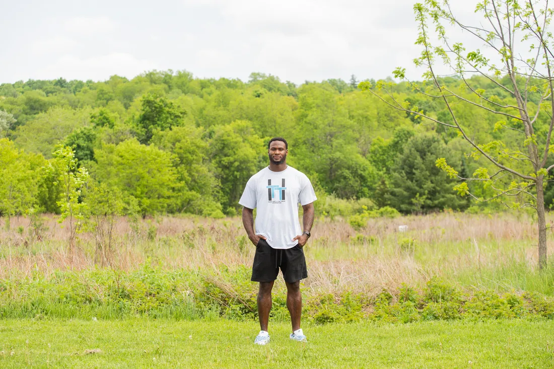 Landscape photo of Latavius Murray standing in front of a grassy field.