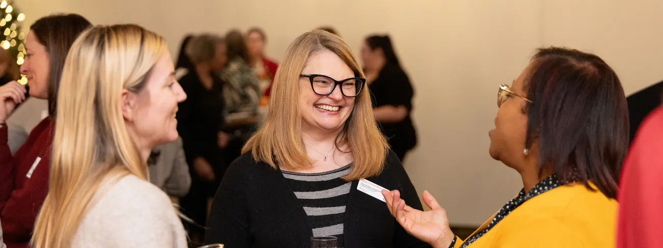 Women in Syracuse University's Women in Leadership Initiative at a holiday celebration.