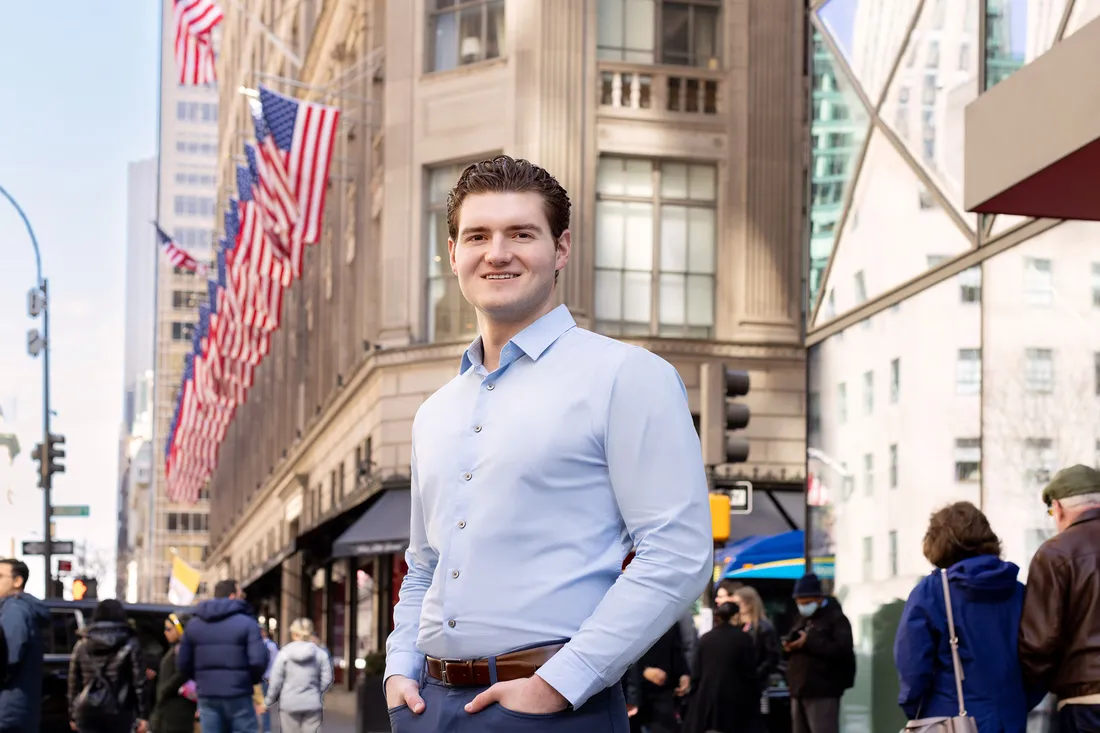 Man in suit standing in the streets of New York City.