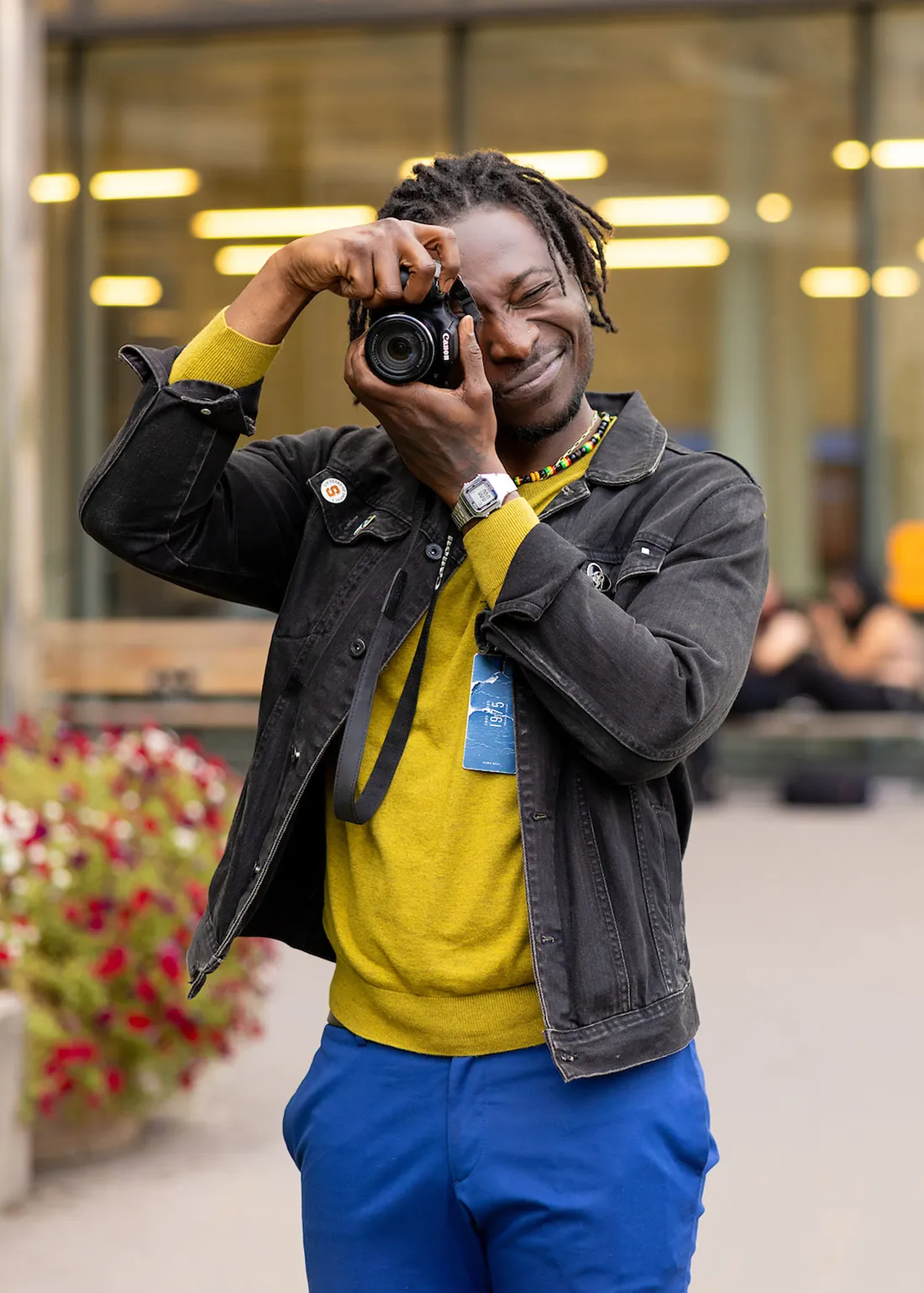 Kofi Dormah holding a camera to his eye.