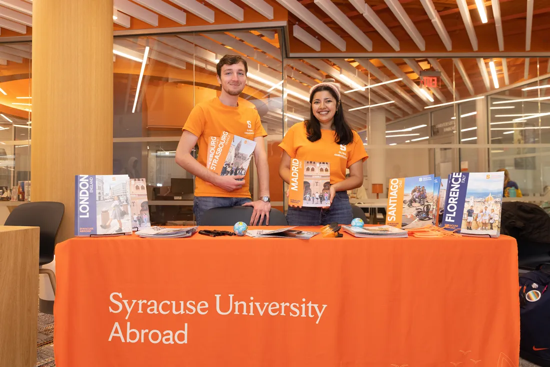 Students at a study abroad information table.