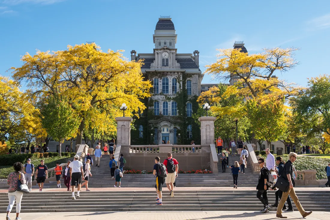 Students walking in front of the Hall of Languages on a sunny day.