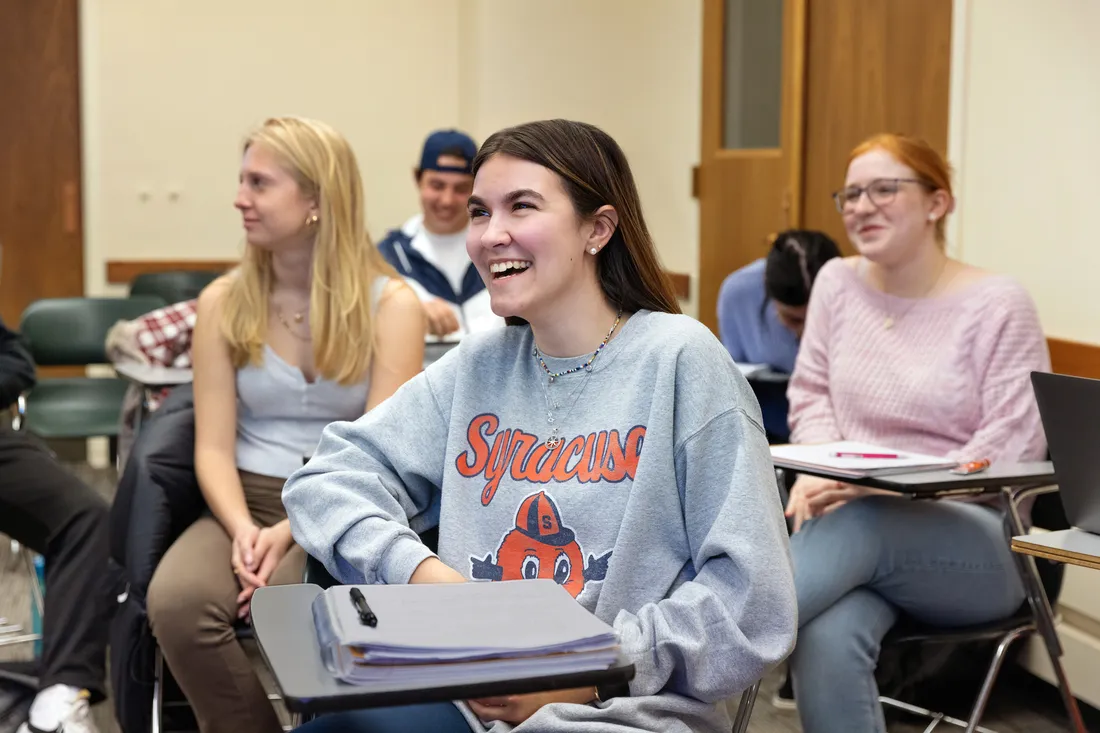 Students sitting at desks in classroom.