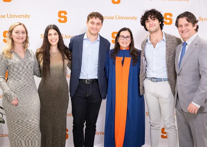 5 Syracuse Promise Scholarship Recipients standing in front of a white background and smiling.