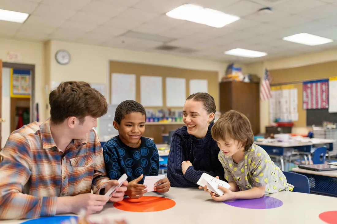 School of Education students in a classroom with children.