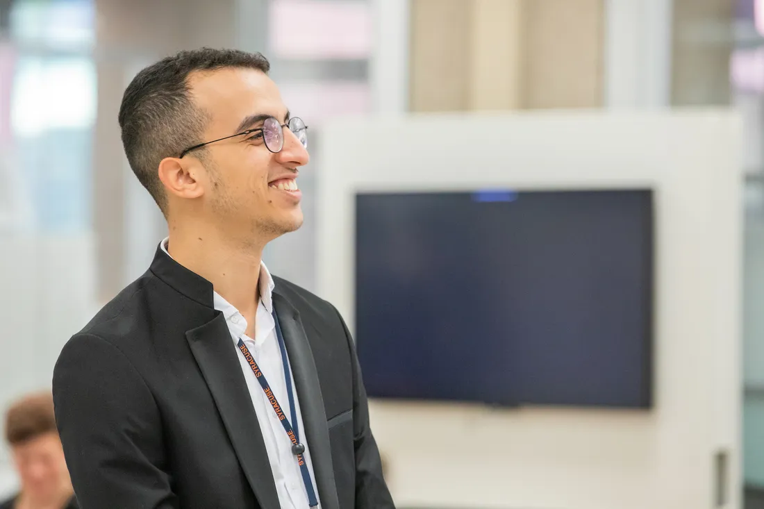 Student standing and smiling.