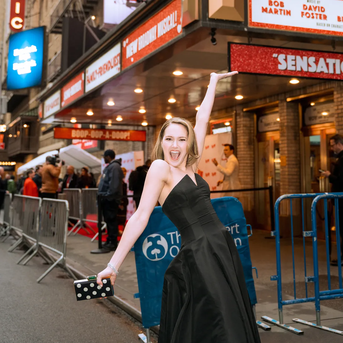 SU alumni actress posing in from of her show.