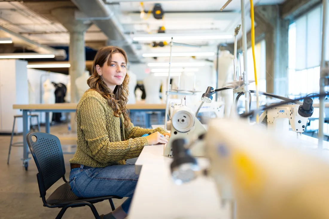 Lilyan Minicozzi at a sewing machine.