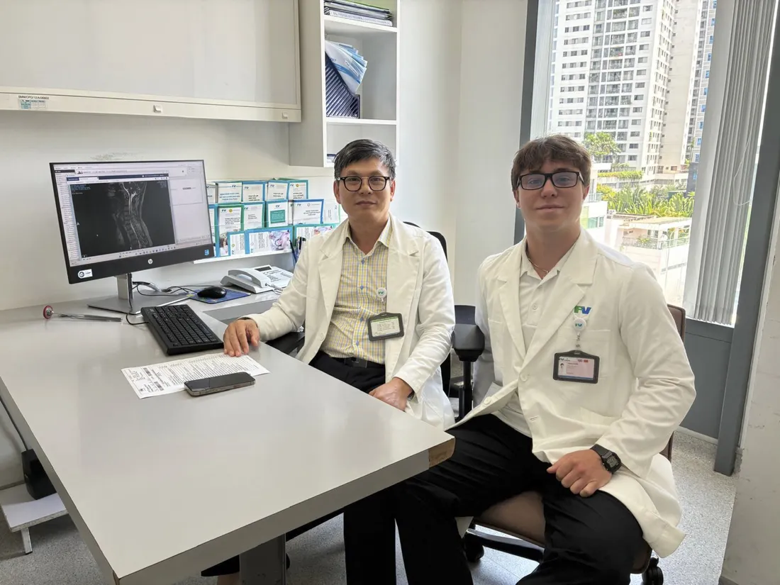 Hank Arditti '29 sitting with a physician at FV International Hospital in Vietnam.