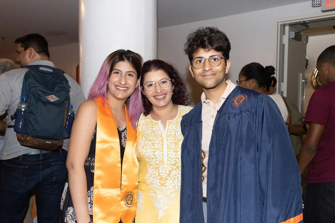 People posing for picture at graduation reception.