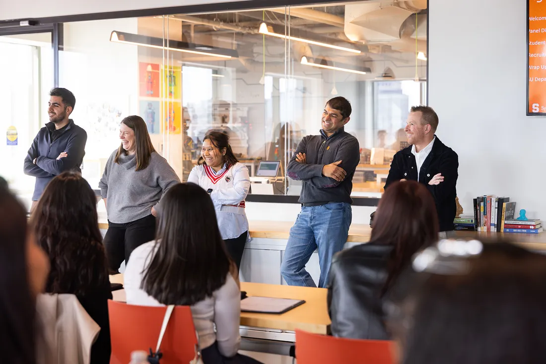 Syracuse University alumni talking to students at Microsoft HQ.