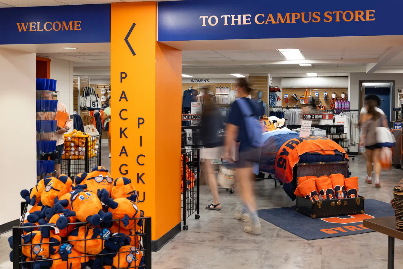 Students walking inside the campus store at Syracuse University.