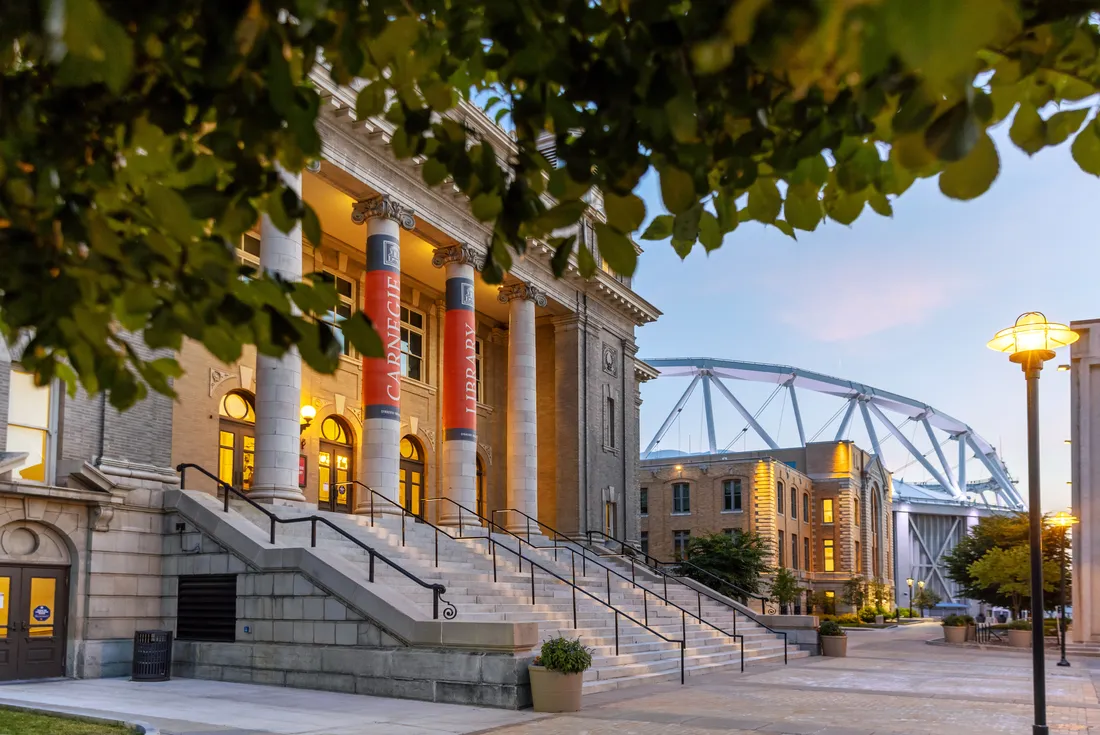 Exterior of Carnegie Library with the JMA Wireless Dome in the background.