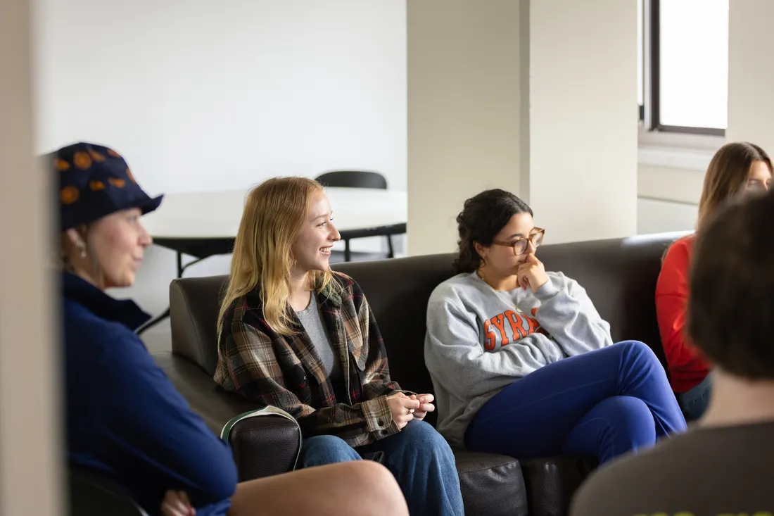 People sitting in a dorm common room.