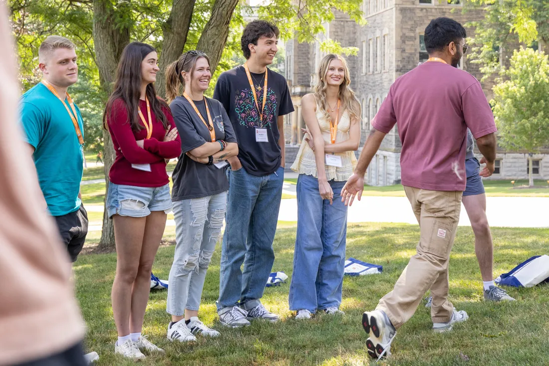 Transfer students outside smiling.