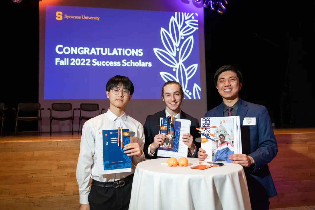 Three SU Students receive congratulations at the SU Success Scholars event.